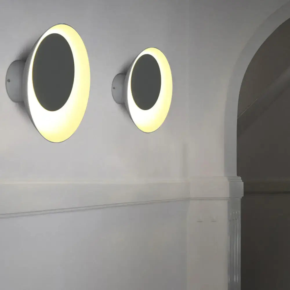 Modern black and pink circle sconce light fixture with white finish and warm yellow led lighting for bedroom wall