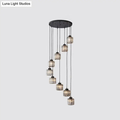 Modern black metal chandelier featuring cascading prismatic crystal cylindrical glass pendants for stairway lighting