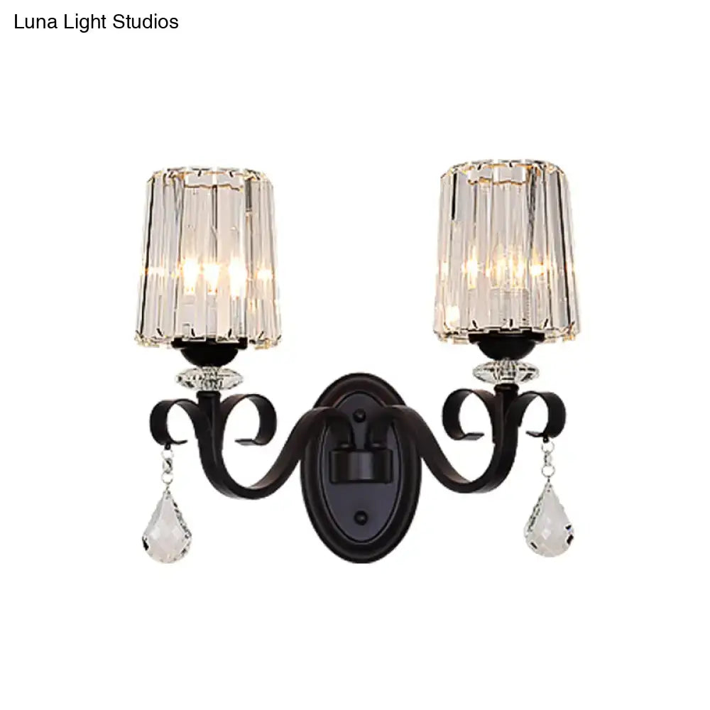 Elegant black wrought iron wall mount lamp with two crystal-framed glass shades and dangling teardrop crystals