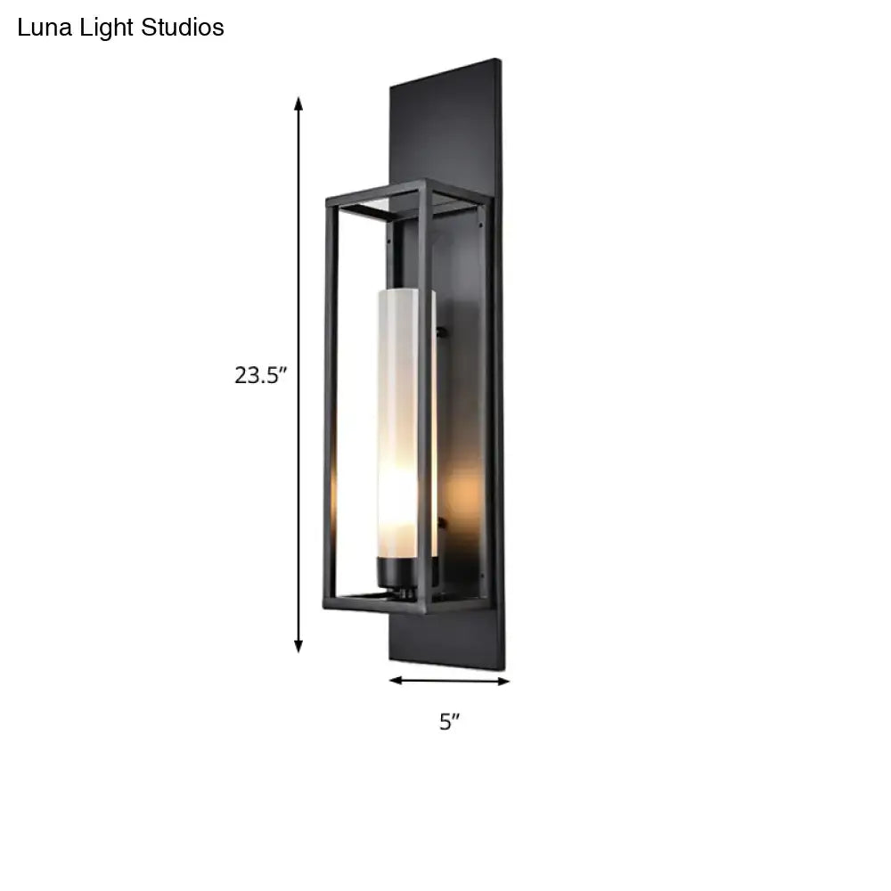Modern black rectangular wall lamp with glass shade featuring a frosted cylinder emitting warm light for living room