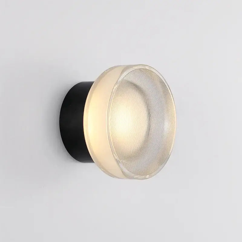 Modern black ribbed glass wall sconce with a cylindrical base and frosted dome for elegant glass led decorbites lighting