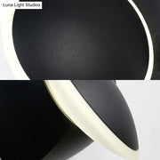 Modern black rotatable led wall sconce with matte finish and integrated white led ring for bedroom lighting