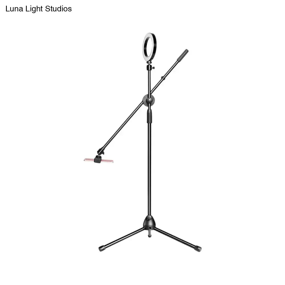 Black metal round led vanity lamp with adjustable arms and tripod base for bedroom use
