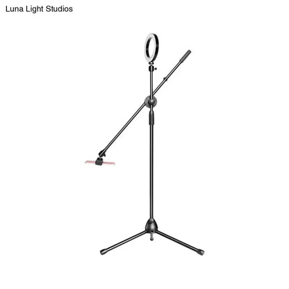 Black metal round led vanity lamp with adjustable arms and tripod base for bedroom use