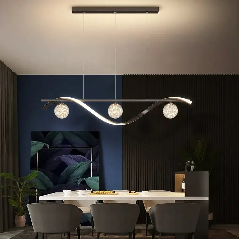 Modern black and silver glass ball led pendant light features a silver-toned curved arm and three spherical glass shades