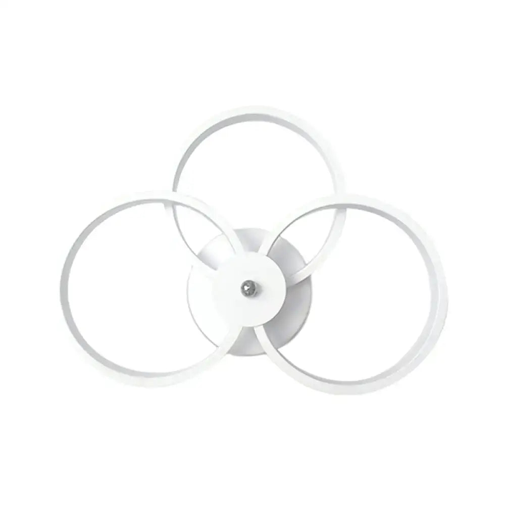 White modern ceiling light fixture with three interlocking rings designed as a wall lamp for bedroom use