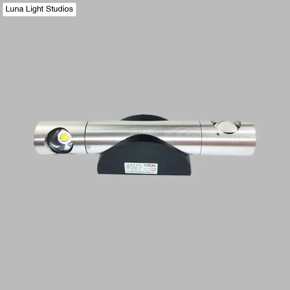 Modern silver cylindrical led light fixture with black base and warm white lighting for living room use