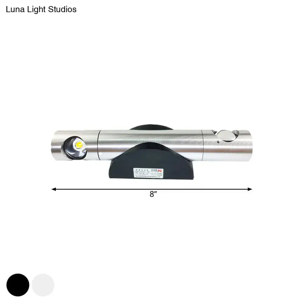 Silver metallic cylindrical flashlight with black base and led bulb for warm white lighting in living room light fixture