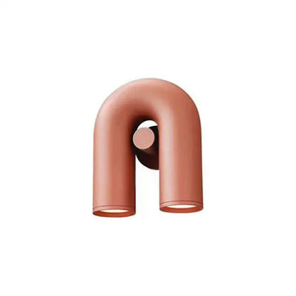 Copper-colored u-shaped wall lamp with a sleek minimalist tube wall design for modern bedroom sconces