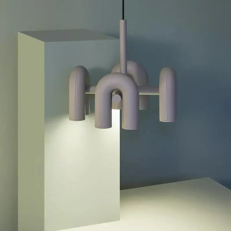 Pastel lavender modernist tube wall lamp with matte ceramic arms in an abstract geometric design for bedroom sconce