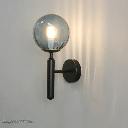Modern black metal wall lamp with a frosted glass ball led globe ideal for bedroom sconce decorbites glass ball lighting