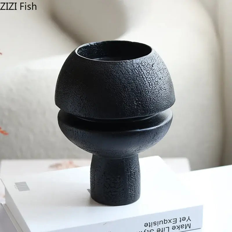 Modern black spherical resin sculpture featuring a black textured ceramic vase with a rounded two-tiered design for decorbites black spherical decor