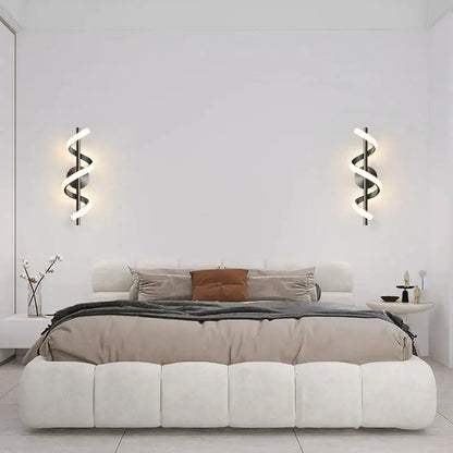 Modern black spiral led wall lamp with glowing white led lights ideal as a stylish bedroom wall lamp