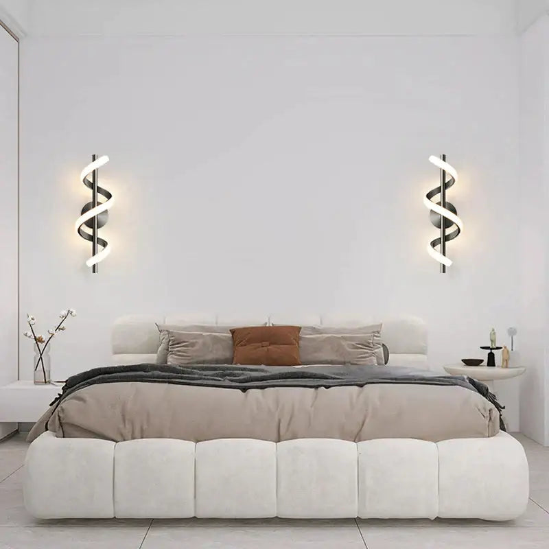 Modern black spiral led wall lamp with glowing white led lights ideal as a stylish bedroom wall lamp