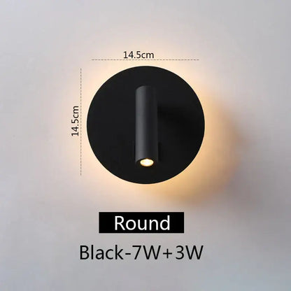 Modern black round led wall lamp with sleek cylindrical light fixture emitting warm illumination for bedroom reading