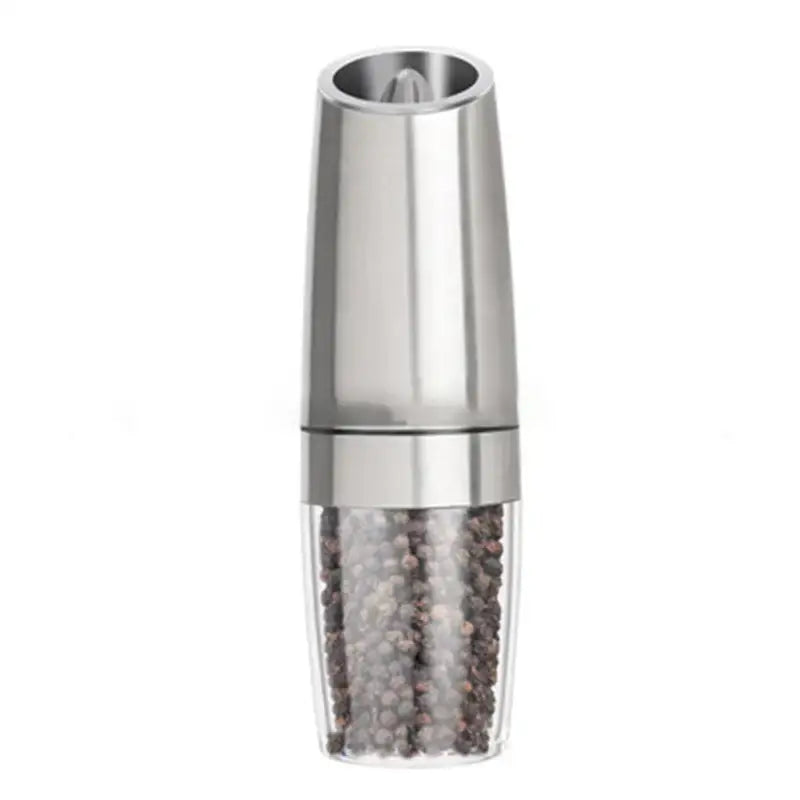 Stainless steel electric salt pepper grinder with clear base filled with black and white peppercorns for kitchen use