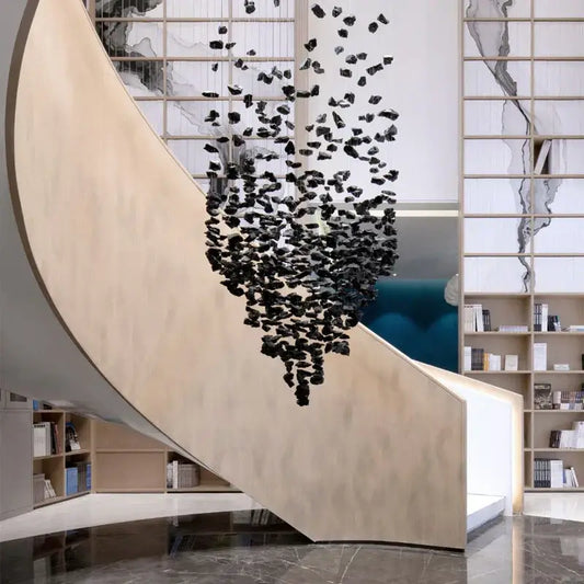 Modern black stone decorbites crystal chandelier suspended above curved wooden staircase for elegant living space lighting