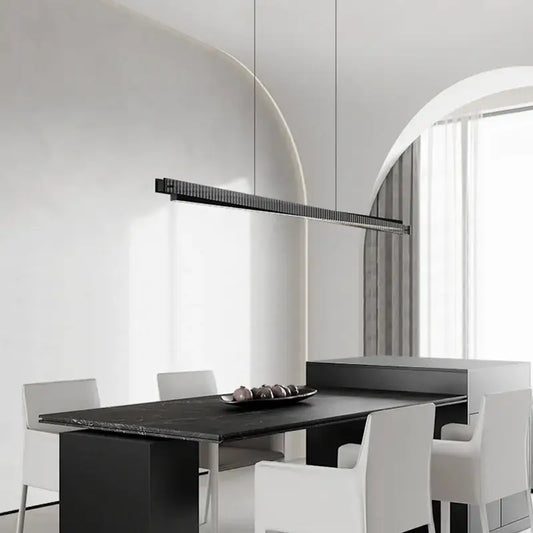 Modern black textured bar shape pendant light with ribbed surface suspended above dining table decorbites bar shape