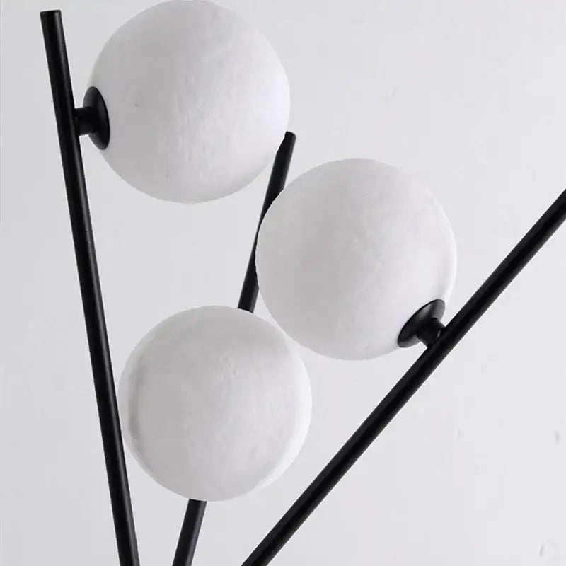 Modern black tripod moon floor lamp with three matte white spherical shades on sleek black metal rods for living room decorbites moon floor lamp