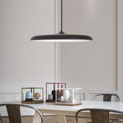 Modern black pendant light with sleek minimalist design and circular illuminated shade as a modern design light source