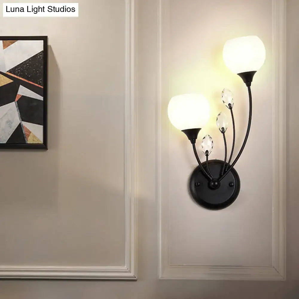 Modern black wall sconce light with three frosted glass globes and crystal accents for living room wall lamp