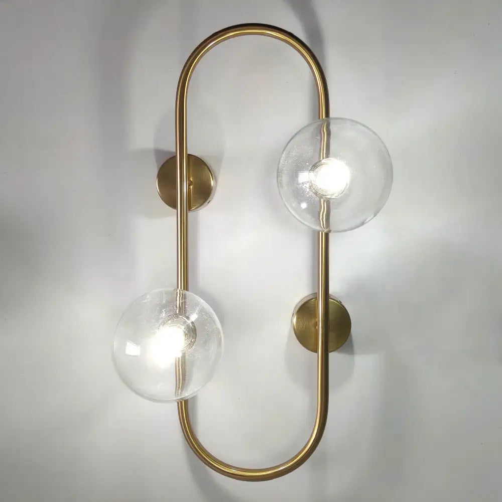 Brass led wall sconce with two clear glass globe shades for modern bedroom decorbites brass led lighting