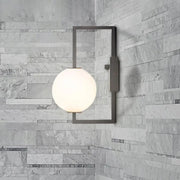 Modern black wall sconce with a frosted white glass orb shade ideal for bedroom lighting