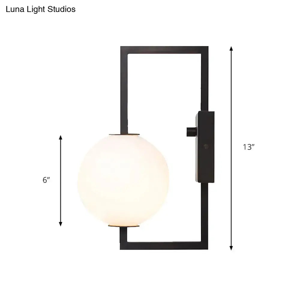 Modern black metal wall sconce with white glass orb and glass orb shade for stylish bedroom lighting