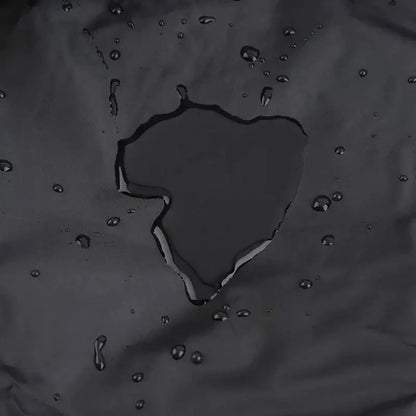 Modern black waterproof bbq grill cover made of dark gray water-resistant fabric with condensation beads visible