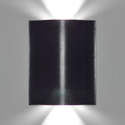 Modern black rectangular wall washer lamp with sleek design emitting warm white lighting from top and bottom beams