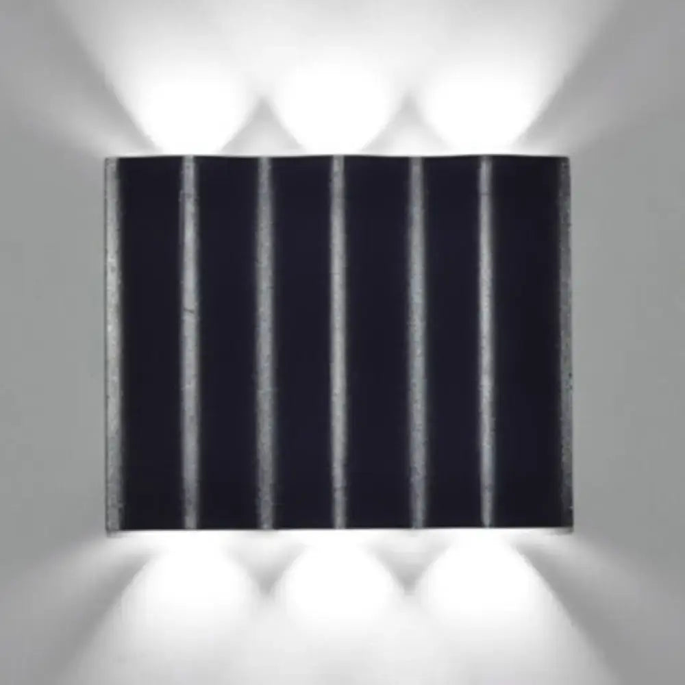 Modern black rectangular wall washer lamp with vertical ridges and matte finish for warm white lighting on porch walls