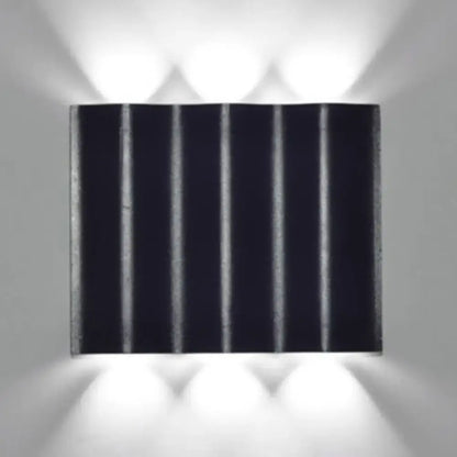 Modern black rectangular wall washer lamp with vertical ridges and matte finish for warm white lighting on porch walls