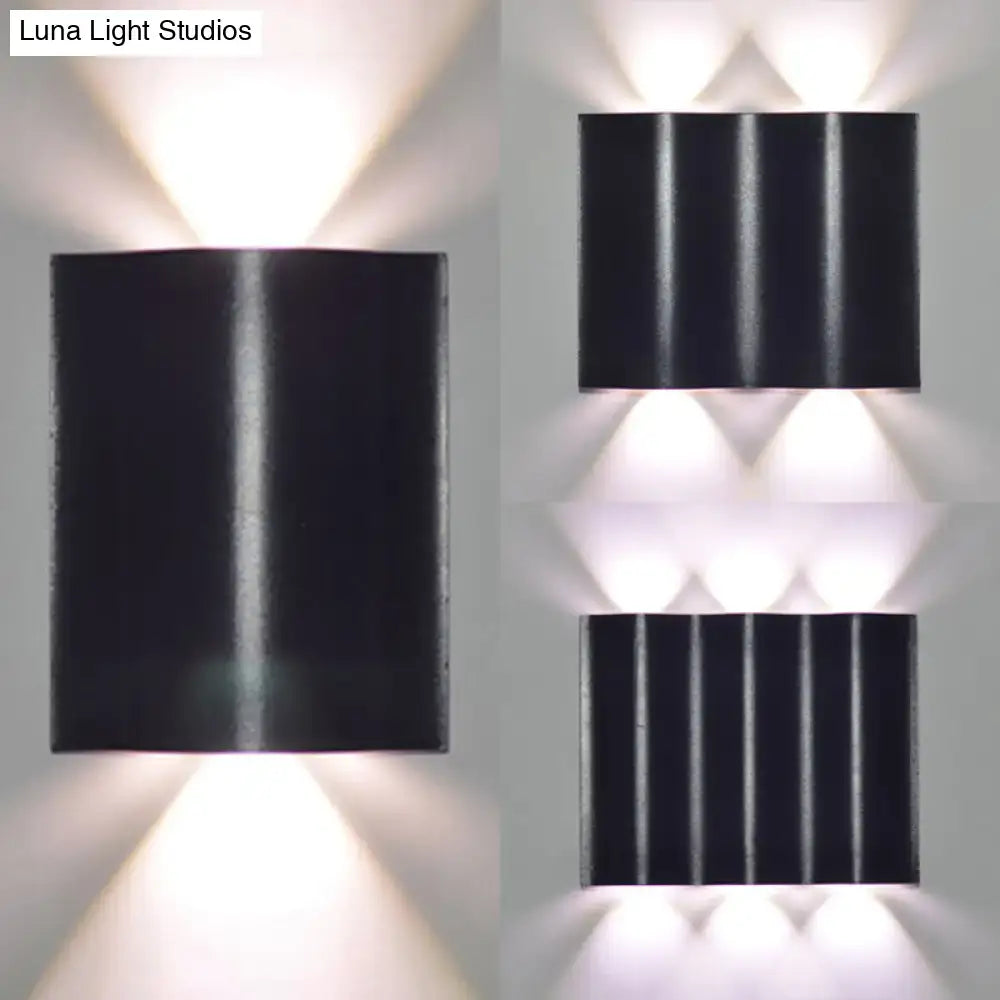Modern black rectangular wall washer lamp with vertical ridges and three downward warm white lighting lights for porch