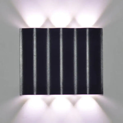 Modern black rectangular wall washer lamp with vertical ridges and matte finish for warm white lighting on porch