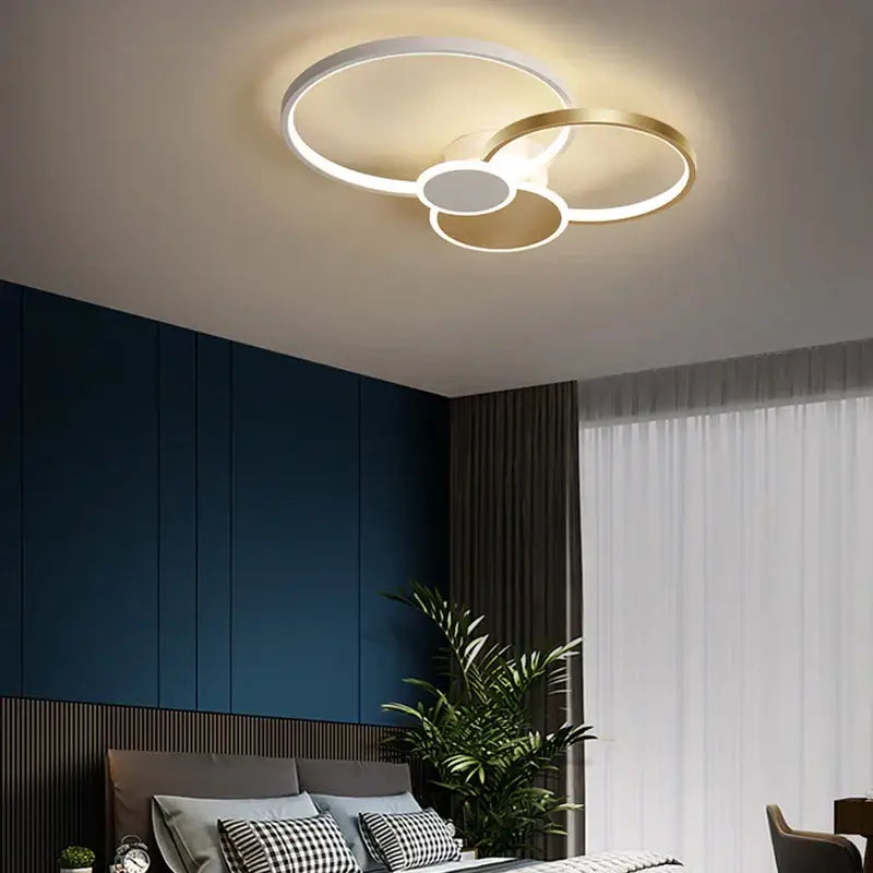 Modern black and white acrylic chandelier light with white and gold interlocking rings for living room ceiling décor