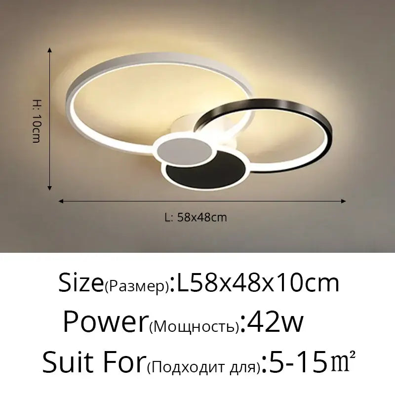 Modern black and white acrylic chandelier light with interlocking rings emitting warm glow for living room use