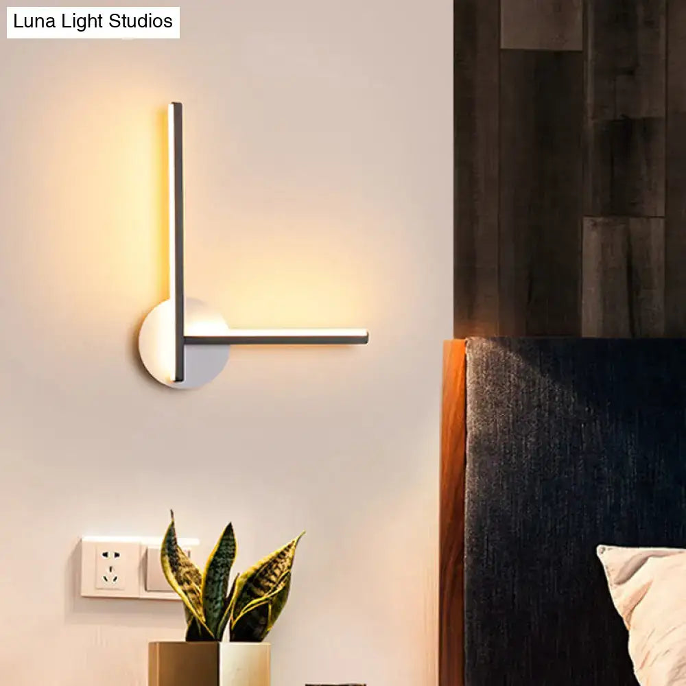 Modern black and white acrylic cross wall sconce with sleek silver frame and warm white led light for bedroom use