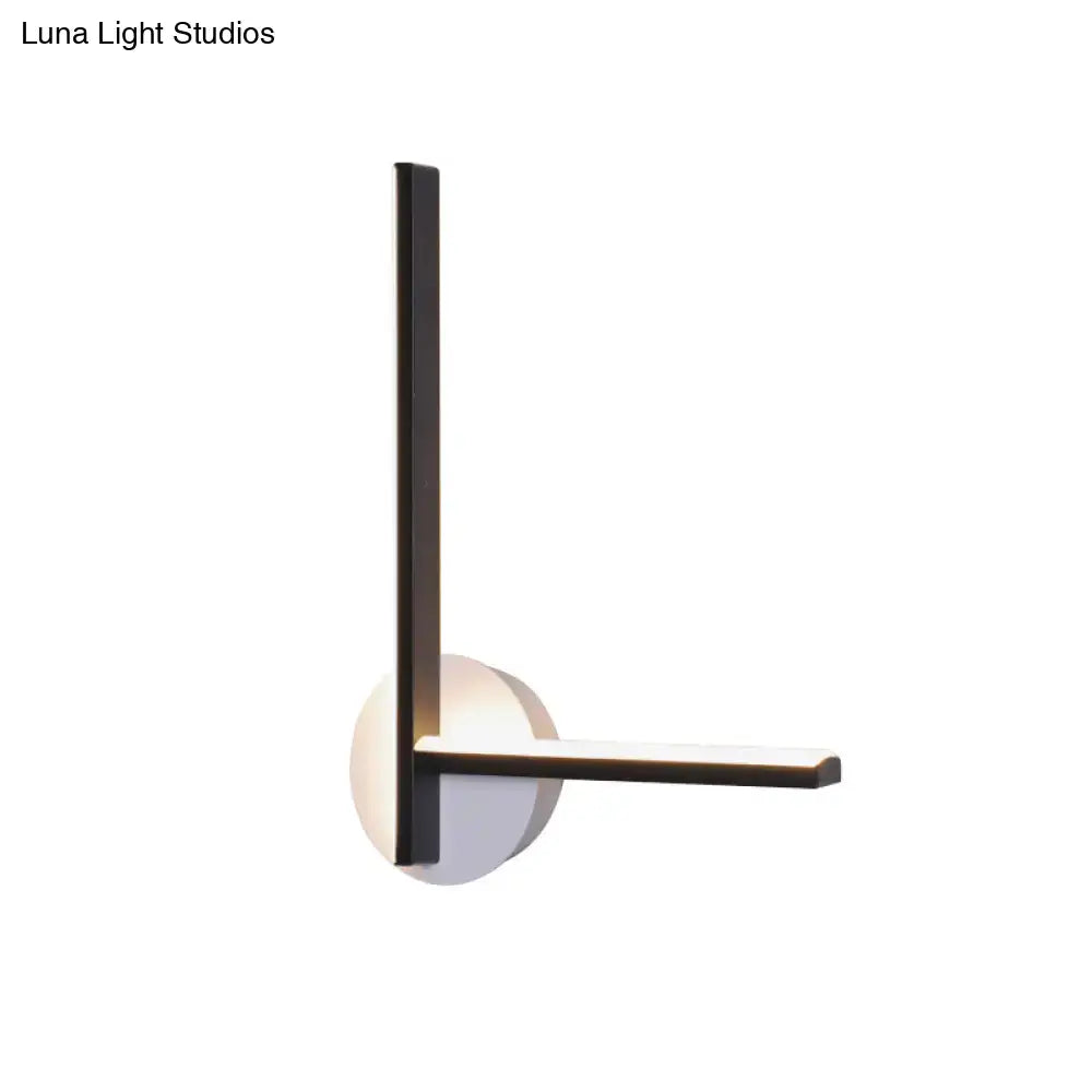 Modern black and white acrylic cross wall sconce with sleek metal frame and warm white light for bedroom use
