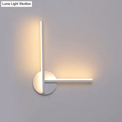 Modern black and white acrylic cross wall sconce with l-shaped design and warm white ambient lighting for bedroom use