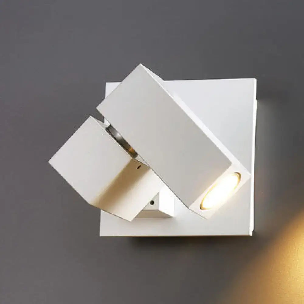 White rectangular wall light with modern angular design and adjustable cube shade for living room use