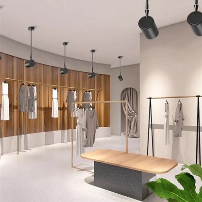 Modern black and white adjustable led wall lamp by decorbites displayed in a minimalist clothing store setting with wooden racks