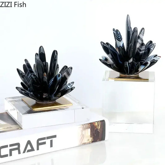 Modern black agate flower crystal art featuring black and white striped agate plant sculptures on gold-toned bases