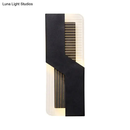 Modern black and white angular led wall mount light with vertical slats emitting warm light for bedroom use