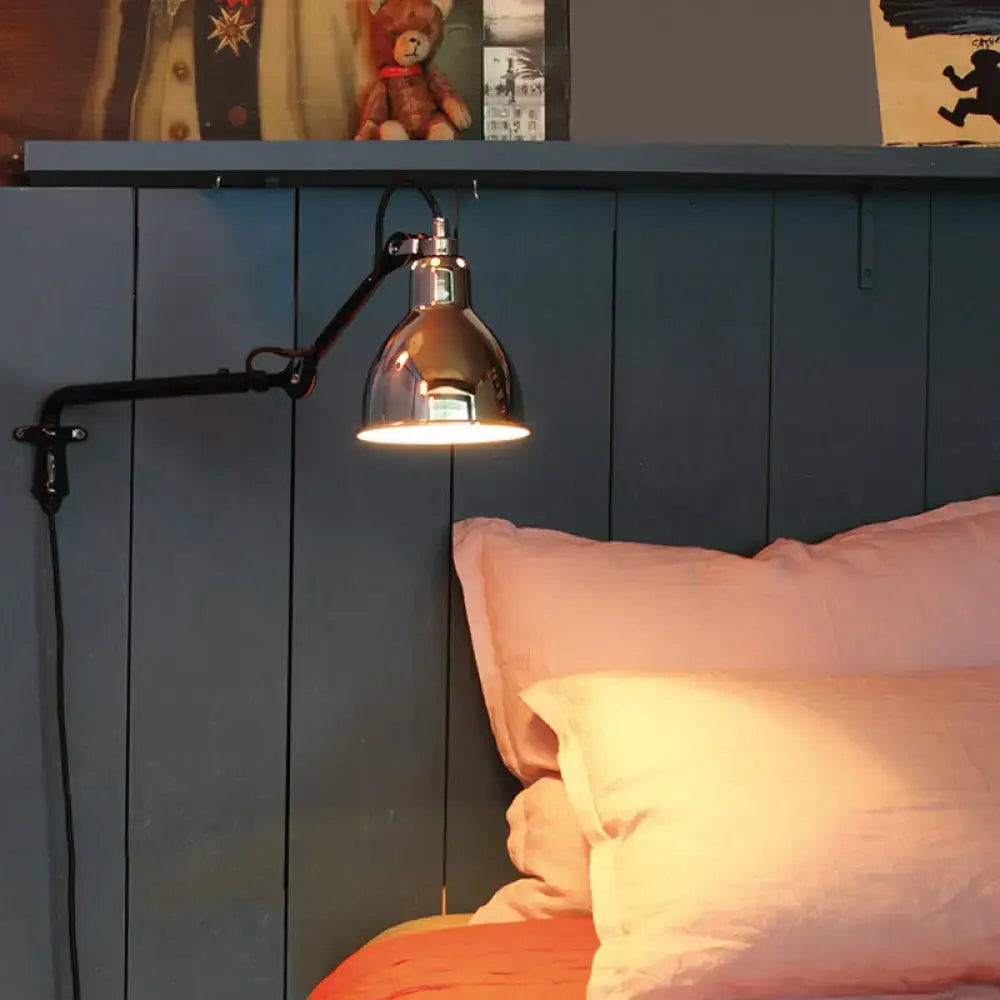 A sleek black and white articulated bedroom wall lamp with brass finish and direct wired electric power source