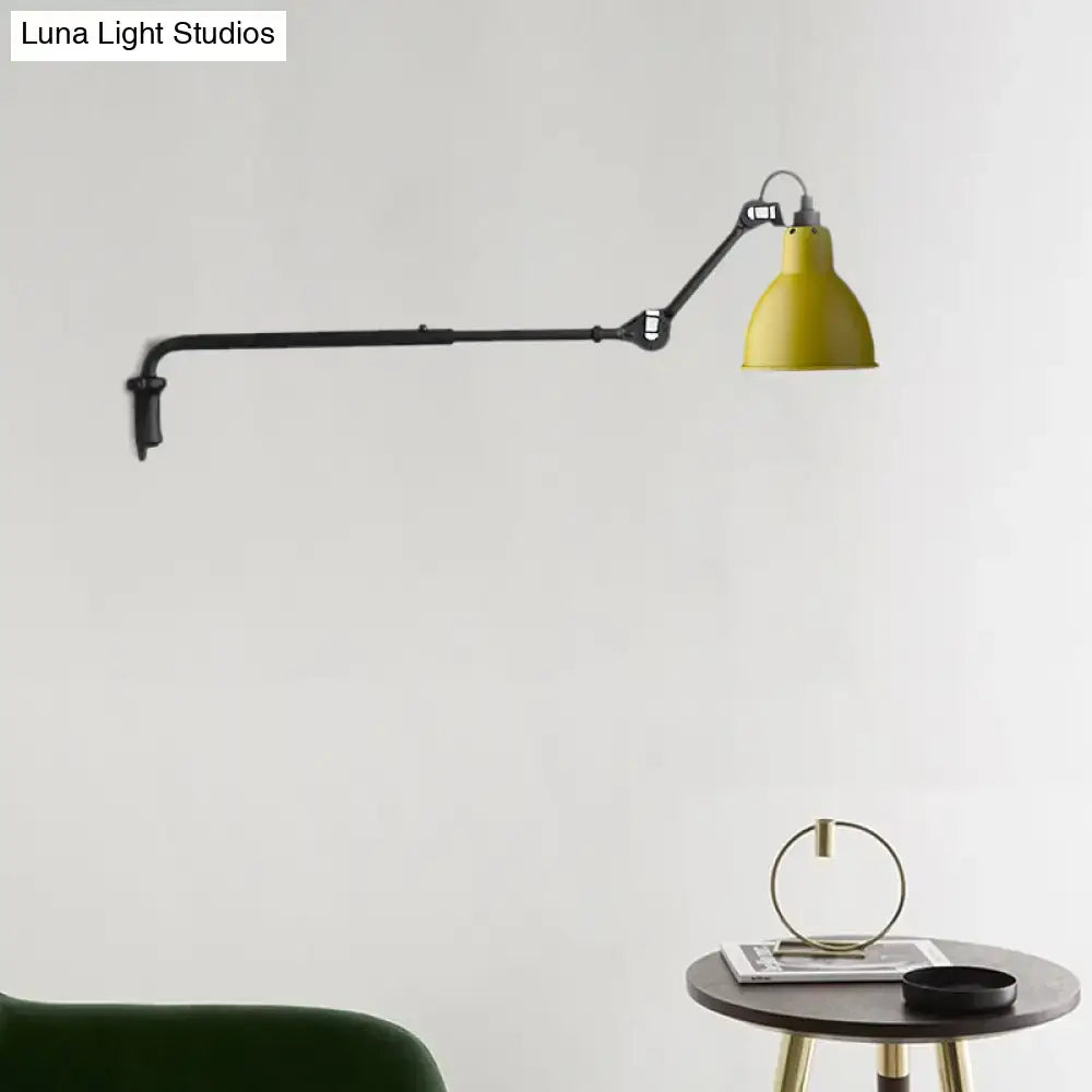 Yellow industrial-style wall-mounted lamp with black articulated arm featuring direct wired electric power source