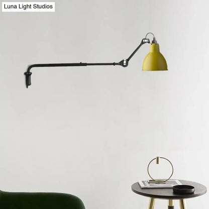Yellow industrial-style wall-mounted lamp with black articulated arm featuring direct wired electric power source