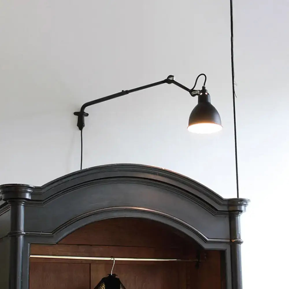 Black articulated wall-mounted lamp with matte finish and adjustable arm featuring direct wired electric power source