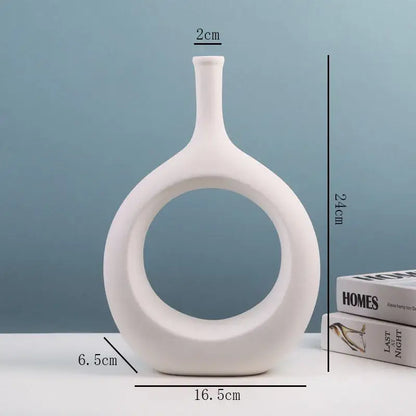 White ceramic vase with sleek modern design and circular cutout from decorbites ceramic vase set for living room decor