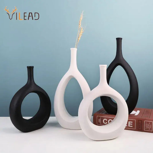 Set of three modern black and white ceramic vases with sleek curved designs and circular cutouts for living room decorbites ceramic vase