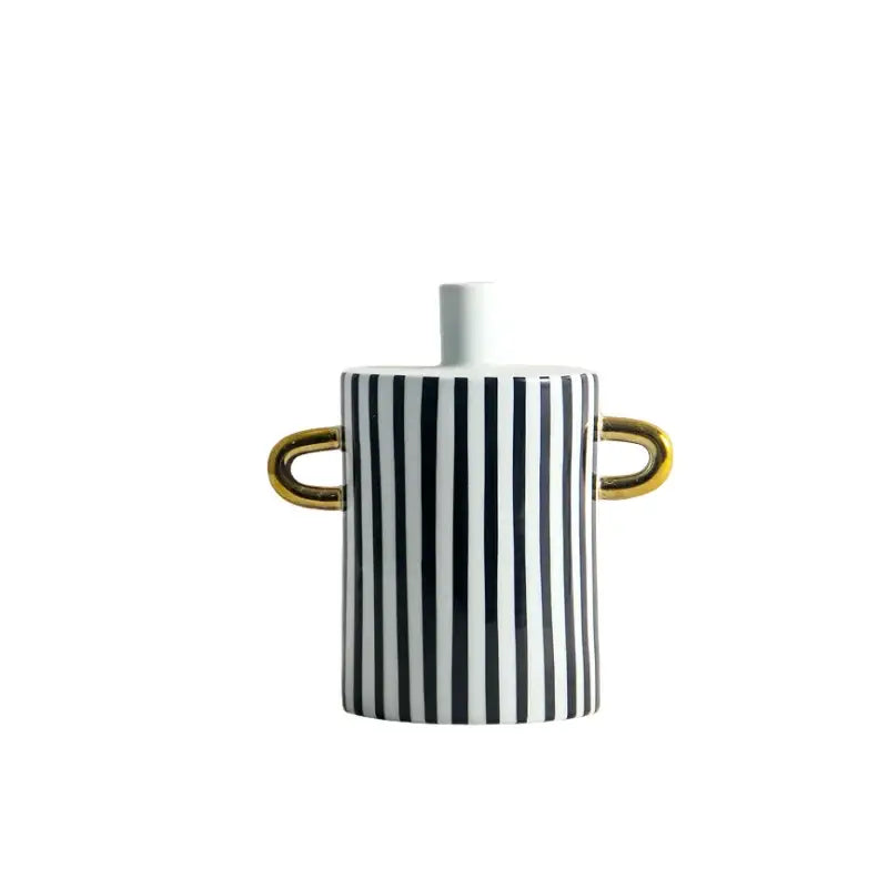 A sleek ceramic vase with black and white dots geometric stripes and gold handles for modern living room decor